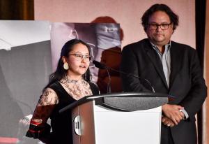 Jesse Wente presents  $50,000 in Technicolor services to filmmaker Isabella Weetaluktuk, who accepts the Technicolor Clyde Gilmour Award on behalf of Zacharias Kunuk 